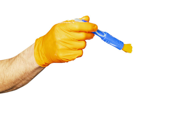 Washing concept. A male man hand with brush isolated on white background. Worker cleaning. Cleaning with cloth, foam and brush. Cleaning concept. Hand in orange protective rubber glove  - Foto, immagini