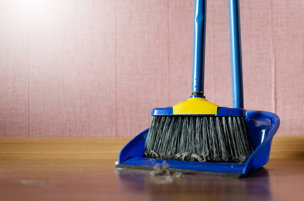 Dust on a house floor and floor brush with dustpan background. Home cleaning concept. - Photo, Image