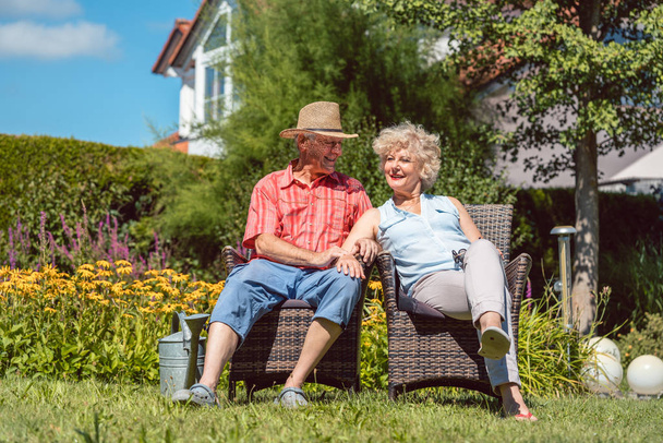 Happy senior couple in love relaxing together in the garden in summer - Photo, Image