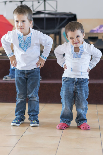 Two little boys perform on stage in kindergarten or school. performance of little boys. - Фото, изображение