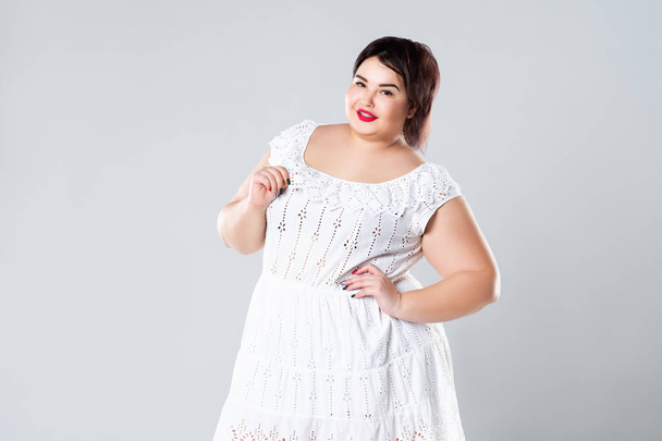 Plus size fashion model in casual clothes, fat woman on gray studio background, overweight female body - Foto, imagen