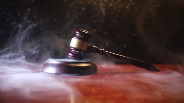 Law theme, mallet of the judge on wooden desk with Lady Justice Statue. Law gavel on dark foggy background with light. Selective focus - Footage, Video