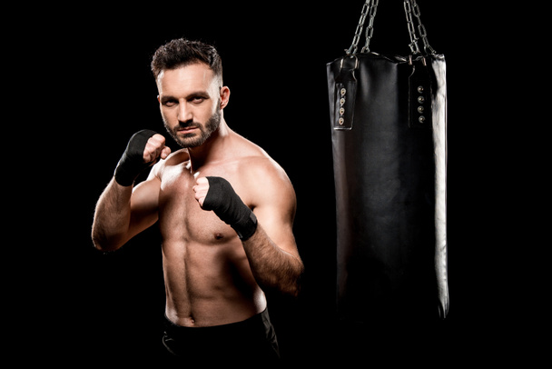 rúgás, lyukasztó zsák elszigetelt fekete izmos boxer - Fotó, kép