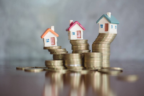 Mini house on stack of coins,Money and house,  Mortgage, Savings money for buy house and loan to business investment for real estate concept. Invesment and Risk Management. - Foto, imagen