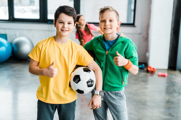 Boys with soccer ball posing with thumbs up - Фото, зображення