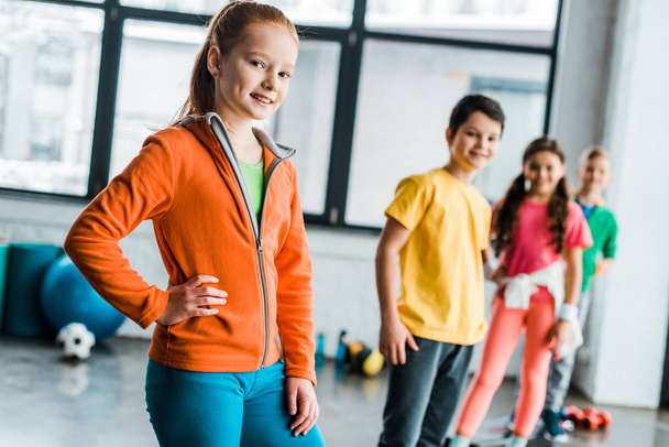 Smiling preteen children posing in gym together - Photo, Image