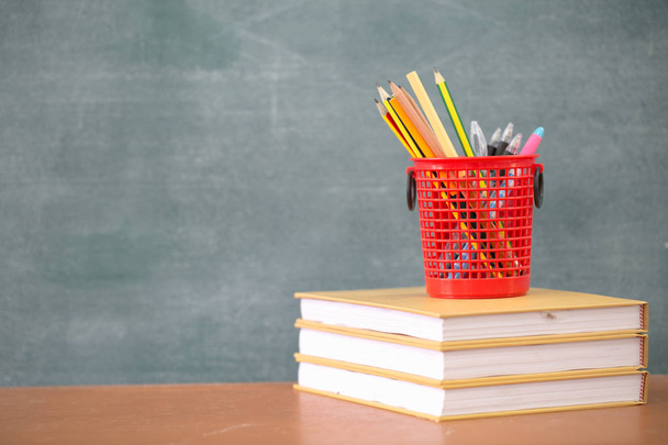 School books on desk, Back to school supplies. Books and a blackboard  background, education concept - Foto, Imagem