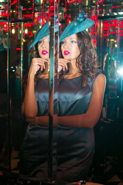Closeup portrait of young beautiful woman in blue dress and designer elegant hat - Fotografie, Obrázek