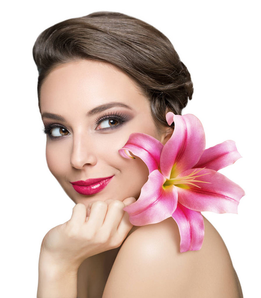 Portrait of a brunette beauty holding colorful flower. - Foto, Imagen