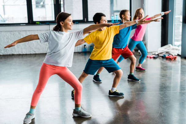 Group of kids doing sport exercise in gym - Photo, Image