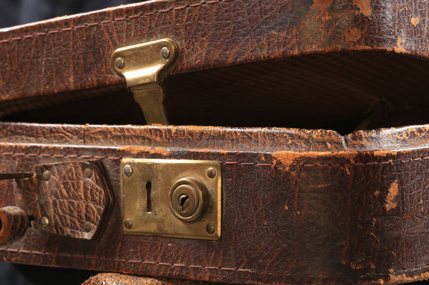 close-up fragment of locks and fasteners on the vintage leather suitcase brown - Fotó, kép