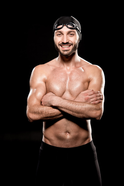 cheerful swimmer standing with crossed arms isolated on black - Photo, Image
