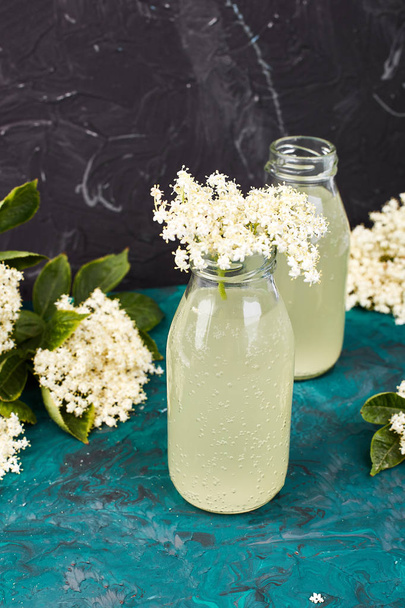 Kombucha tea with elderflower on green background. Homemade fermented infused drink. Summer Healthy natural probiotic flavored drink. Copy spac - Photo, Image