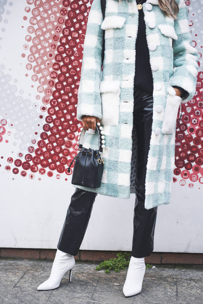 Milan, Italy - February 24, 2018: Fashion influencer wearing an urban outfit, posing on the street during Milan Fashion Week. - Fotó, kép