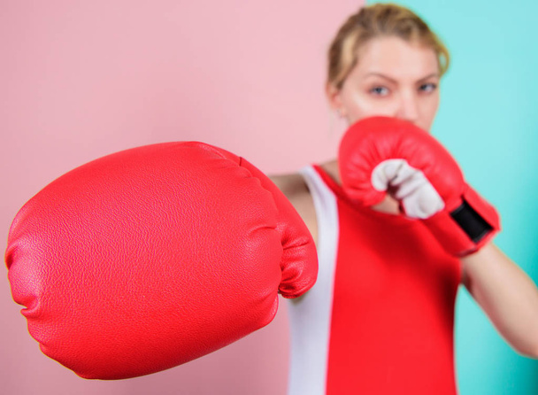 Ambitious girl fight boxing gloves. Female rights. I am gonna kick you off. Confident in her boxing skill. Boxing improve temper and will. Concentrated on punch. Woman boxing gloves focused on attack - Photo, image