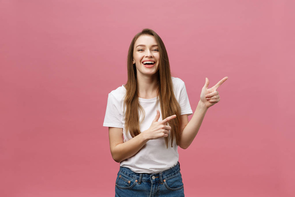 Woman pointing finger at camera and toothy smiling. Expression emotion and feelings concept. Studio shot, isolated on pink background - Fotografie, Obrázek
