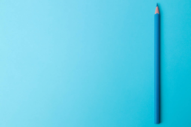 Composition with a blue pencil on a bright trend blue background. view from above. space for text - Foto, immagini