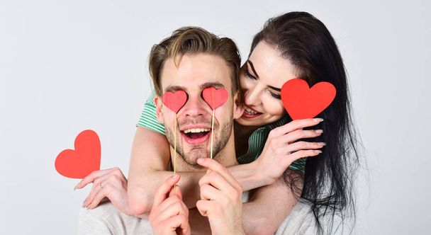 Valentines day concept. Valentines day and love. Romantic ideas celebrate valentines day. Man and pretty girl in love. Man and woman couple in love hold red heart valentines cards white background - Photo, image