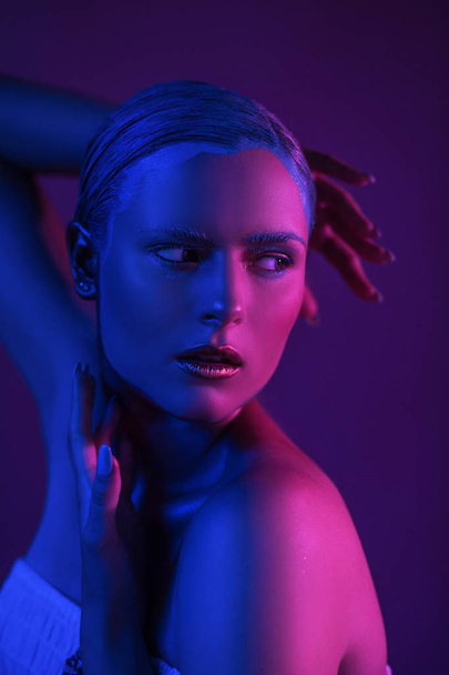 Glitter Neon Lights on Skin of Sexy Young Model in Photo Studio - Foto, Imagem