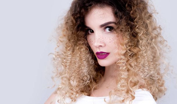 Young beautiful woman with freckles and curly hair studio portrait - Fotoğraf, Görsel