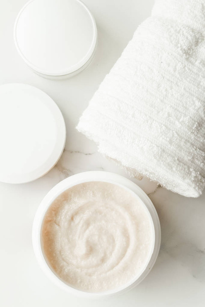 Scrub and exfoliating cream products on a marble, flatlay - skincare and body care, luxury spa and clean cosmetic concept. Health and beauty of your skin - 写真・画像