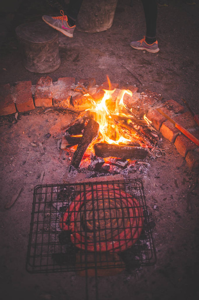 Close up image of boerewors / sausage on a braai / barbeque on a farm in the karoo in south africa - Fotó, kép