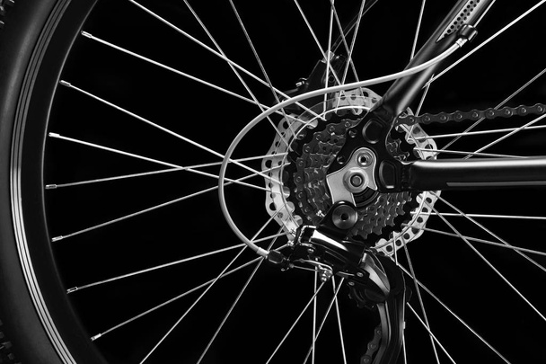 Mountain bicycle photography in studio. Bike wheel with disc brakes and chain. Bike part. - Foto, imagen
