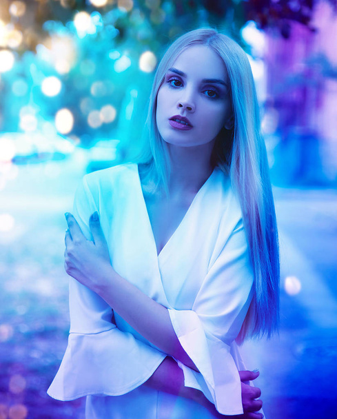Young woman in colorful bright lights  - Фото, зображення
