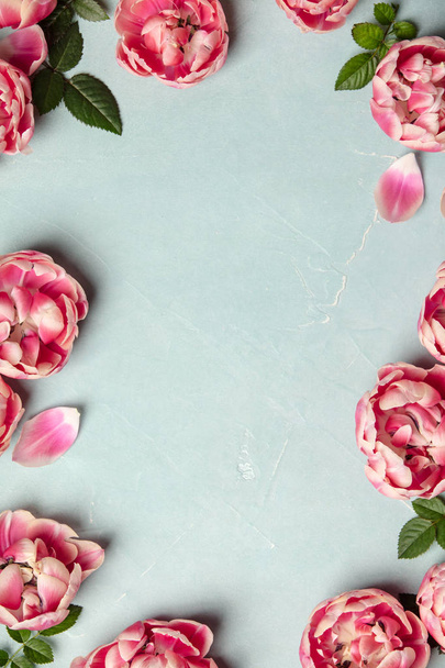 Border of beautiful pink tulips on blue shabby chic background, frame, top view, floral border - Φωτογραφία, εικόνα