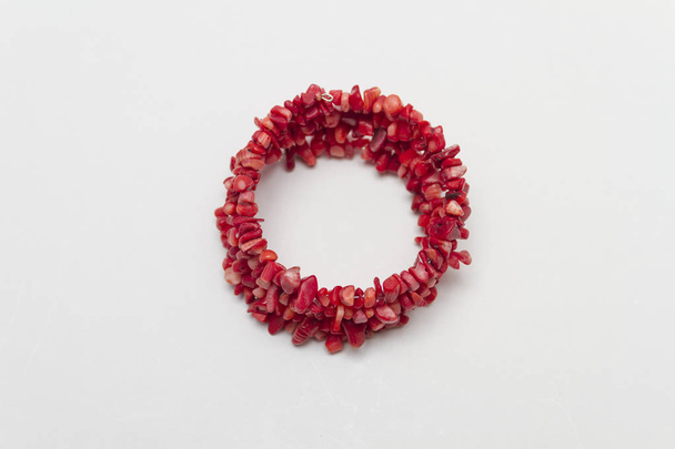 Close up of red women bracelet on white background - Foto, immagini