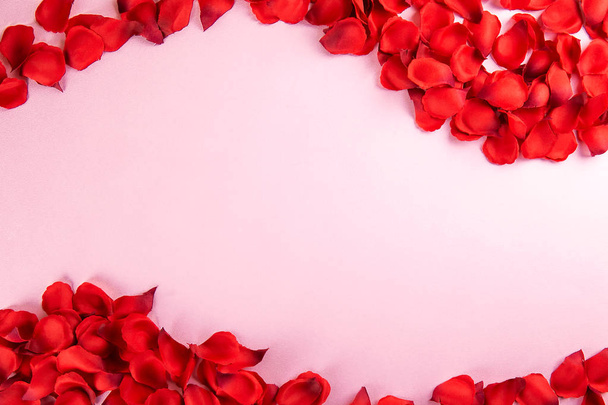 Romantic happy valentines day greeting card, wedding invitation, women's day concept. white background covered with deep red, scarlet, crimson rose petals. Close up, top view, copy space, mock up. - 写真・画像