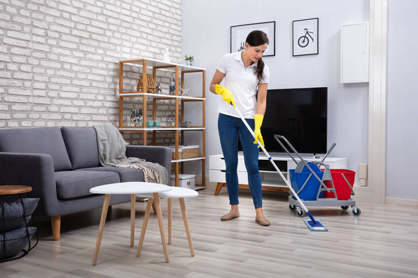 Female Janitor Cleaning Floor With Mop In Living Room - Zdjęcie, obraz