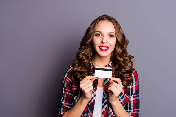 Close up portrait of beautiful amazing toothy beaming smile she her lady arm hold  promo advice credit card just got new version for job work wearing casual checkered shirt isolated grey background - Photo, Image