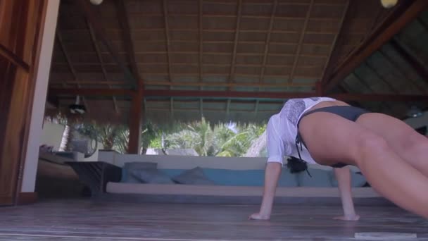 young healthy woman making yoga exercises in bungalow house - 映像、動画