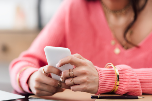 cropped view of woman in pink clothes using smartphone - Fotoğraf, Görsel