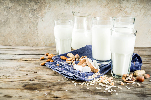 plant based vegan food and drink, Non-dairy milk and cheese tofu - from almond, nuts, soy beans, oats and coconut, wooden background copy space - Photo, Image