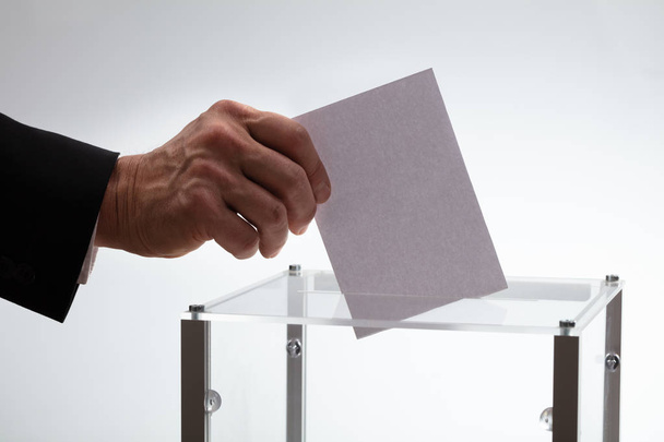 Close-up Of Businessman's Hand Inserting Ballot In A Glass Box - Фото, зображення