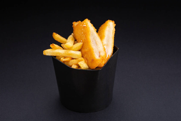 tempura Chicken slices with French fries and fresh vegetables on a black background. - Foto, Imagem