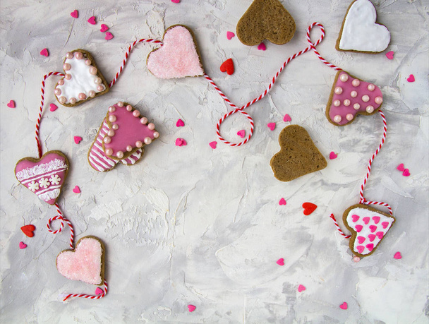 Valentine's day with a hearts, cookies in the shape of a heart, Icing, Red ribbon on Vintage gray texture table Top View Copy Space Gingerbread painting Vertical Postcard - Valokuva, kuva