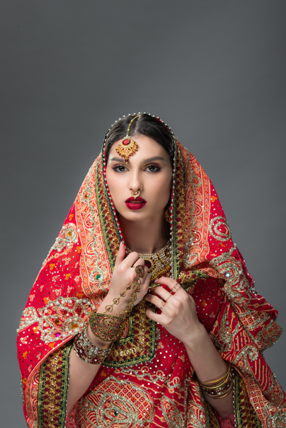 beautiful indian woman posing in traditional sari, isolated on grey  - Zdjęcie, obraz