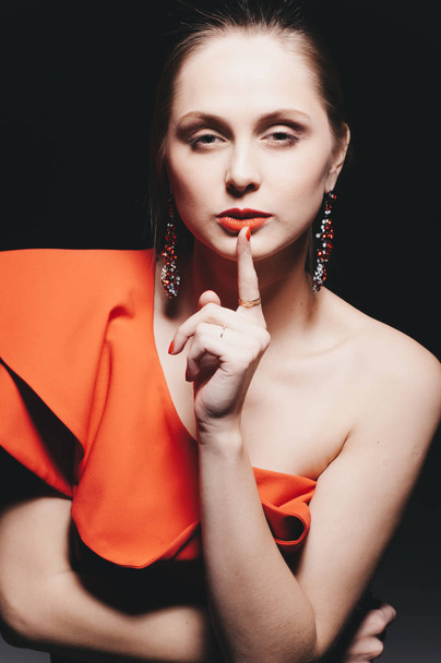 beautiful young caucasian woman wearing red dress posing at studio - Fotografie, Obrázek