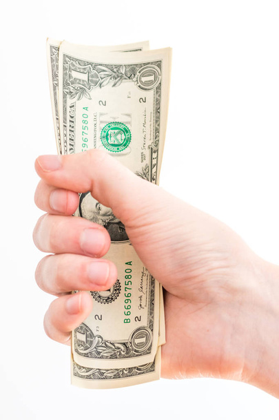 Ένα δολάριο ΗΠΑ χαρτονομίσματα στο χέρι ο άνθρωπος. - Φωτογραφία, εικόνα