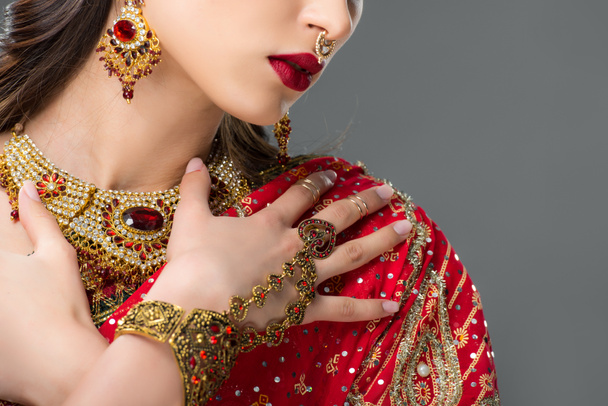 cropped view of woman posing in indian sari and accessories, isolated on grey  - Photo, Image