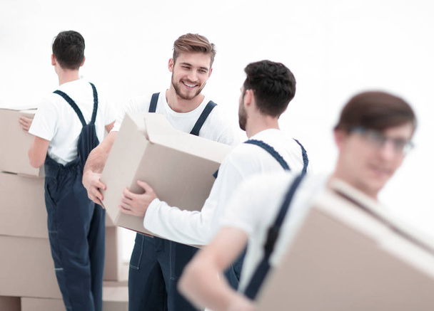 Portrait of movers holding box smiling isolated on white backgro - Photo, Image