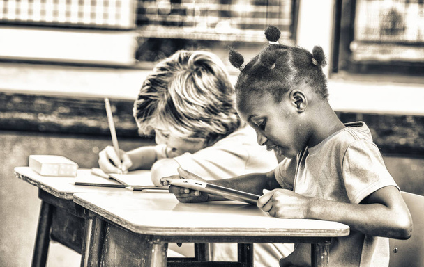 African girl and caucasian boy at elementary school. - 写真・画像