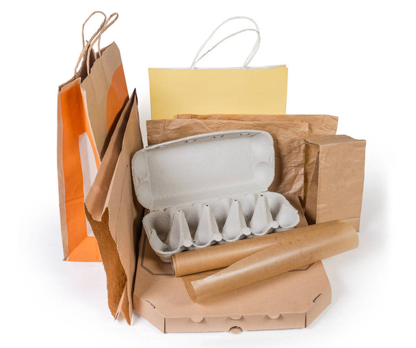 Different brown paper food packaging, carton box, other packing for various foods and shopping bags without plastic on a white background - Photo, Image