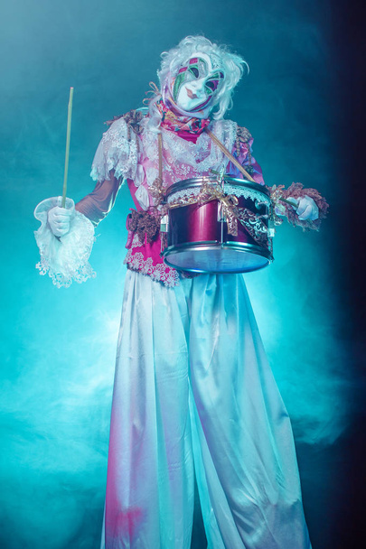 woman in venetian costume, mask and wig posing with drum against misty background - Zdjęcie, obraz