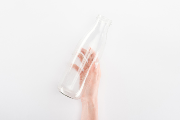 Cropped view of woman holding empty glass bottle  - Фото, изображение