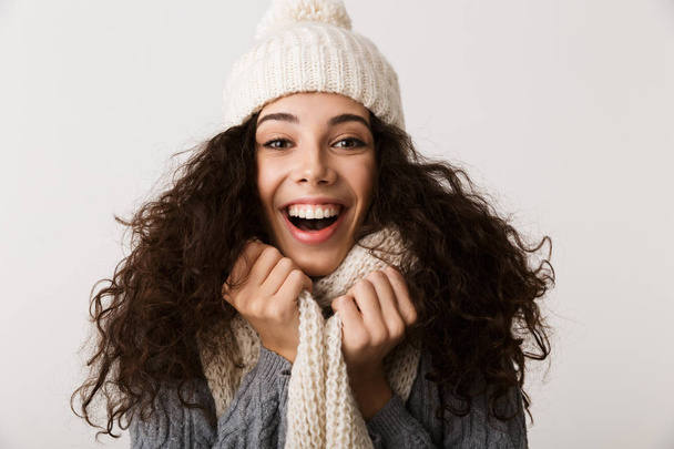 Cheerful young woman wearing winter scarf standing isolated over white background - Φωτογραφία, εικόνα