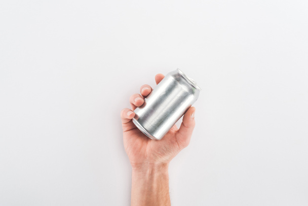 Cropped view of man holding empty can on grey background - Fotografie, Obrázek